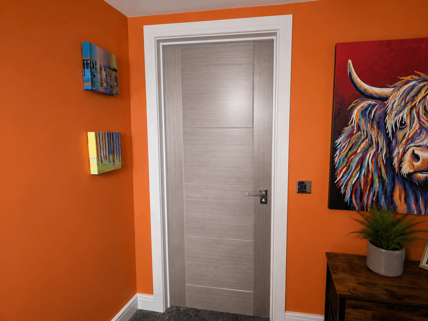 Internal door by The Door Fitting Company in room with orange walls