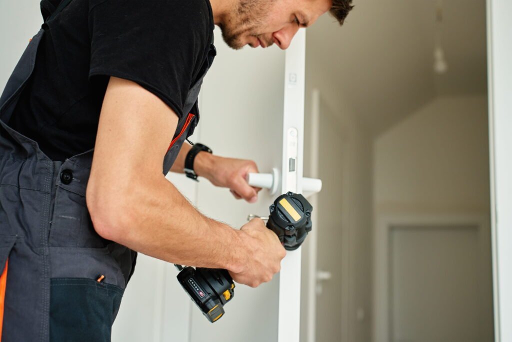 How much does it cost to fit an internal door showing tradesman fitting an internal door.